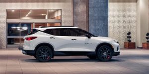 White 2021 Chevrolet Blazer parked in front of a building.