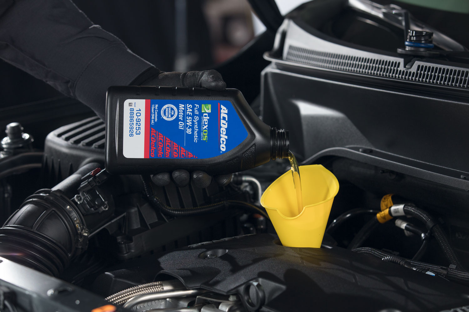 Chevy service technician conducting an oil change